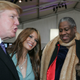 Image of André Leon Talley with Donald Trump and Melania Trump at Fashion Week in 2005 via Getty